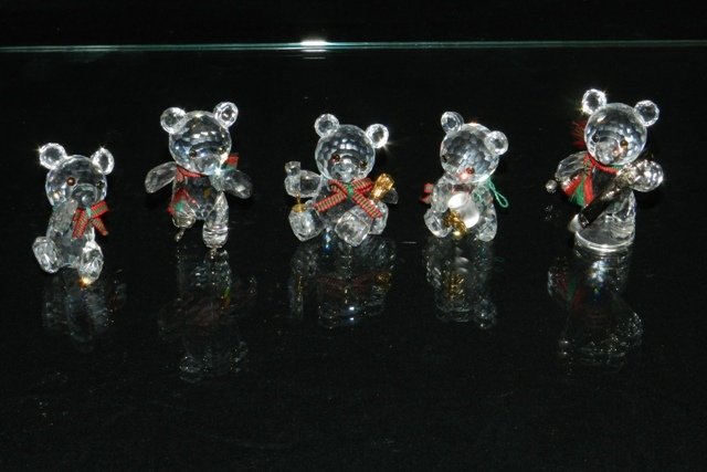 5pc. SWAROVSKI CRYSTAL KRIS BEARS COLLECTION: 5pc. Swarovski crystal Kris bear figurines include - 7637 000 001, issued 1993 retired 2001; Bear on skates 7637 000 002, issued 1995 retired 2004; Bear with honey pot 7637 000 003, issued 1997 retire