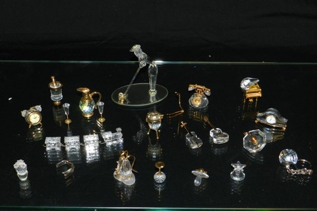 20pc. MINIATURE SWAROVSKI CRYSTAL COLLECTION: 20pc. Miniature Swarovski crystal collection including man golfing, train set, piano, clock, ice bucket & champagne glasses, telephone, ballet shoes, umbrella, guitar, drum, pacifier, keychain, etc. M