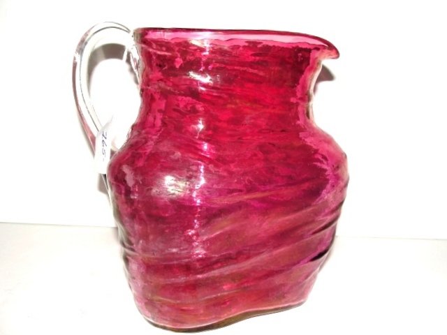 Victorian Triangle Form Cranberry Flash Pitcher: Hard to find triangle pitcher with uneven molded layered body and applied handle, and broken or blow pipe pontal. Condition good, light wear to flash. 8'' tall 6 3/4'' at widest point.