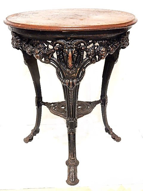 Vintage Arighi BianchiÂ C.I. Rams Head Table: Cast iron table with pierced apron skirt with three legs featuring ram heads cornucopia's and foliage tapering down to hoof type foot. Clearly stamped on bottom of center shelf. Condition very good, w