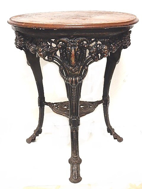 Vintage Arighi BianchiÂ C.I. Rams Head Table: Cast iron table with pierced apron skirt with three legs featuring ram heads cornucopia's and foliage tapering down to hoof type foot. Clearly stamped on bottom of center shelf. Condition very good, w