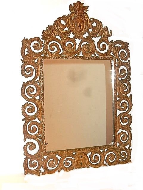 Antique Mask Ornate Bronze Renaissance Mirror: Having crest with ladies face surrounded with foliate designs around the top and sides. From Anne & Leo Narosny Estate. Condition overall good, oxidation, slight bend on frame at bottom right and chip