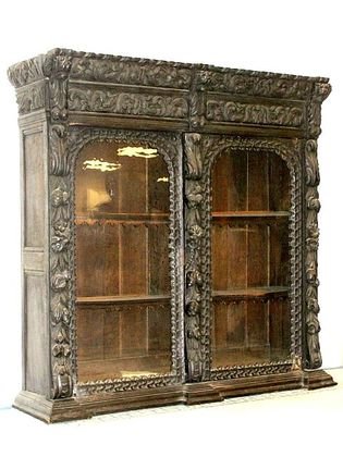 Carved English Oak Cabinet Top: English carved two door oak bookcase or cabinet top. Heavily carved typical English carving detail of mask faces and foliage. Condition one door missing part of inset hinge. EST size only H. 58'' W. 5