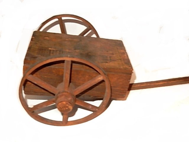 Late 19th. C. Litho Musical Wood Pull Toy Cart: Wooden musical pull cart with long handle, paper litho on top and back of Washington D.C. and the Capitol Buildings on top, back paper litho naming the first 23 presidents of the United States of Amer