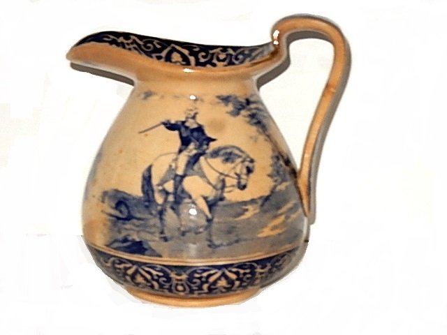 Buffalo Pottery George Washington Pitcher 1907: Blue transfer decoration with scenes of Geo. Washington and Mt. Vernon gilt highlights, dated 1907. United States.