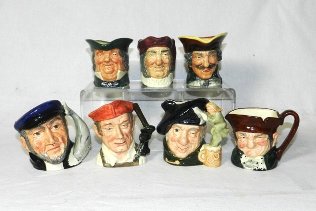 Group of Seven Smaller Royal Doulton Toby Mugs: All free from cracks/chipping. All 3" to 4" tall. Included is D5527 Old Charley, D6636 Tam O'Shanter, D6506 Capt. Ahab, D6578 Blacksmith, plus three (3) male figures with no name/number.