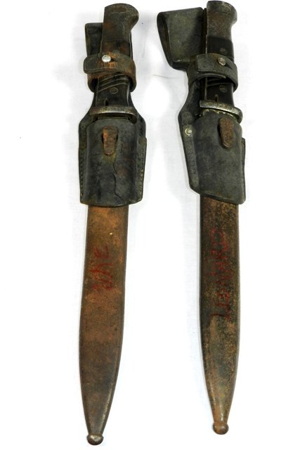 Two Coppel GmbH WWII Bayonets: Set of two Coppel GmbH German WWII Mauser K98 bayonets. Both bayonets have original scabbard and Bakelite handles. Moderate rust on both bayonets and scabbards. 15.25" long.
