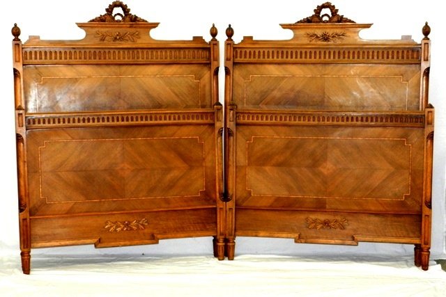 French Satinwood Beds 19th. C.: Late 19th C. French satinwood twin beds, carved floral crest, quarter inch string inlay, removable finials. Matches lots 395 and 401. Note, finish is bleached out. H 58" x w 47.5"