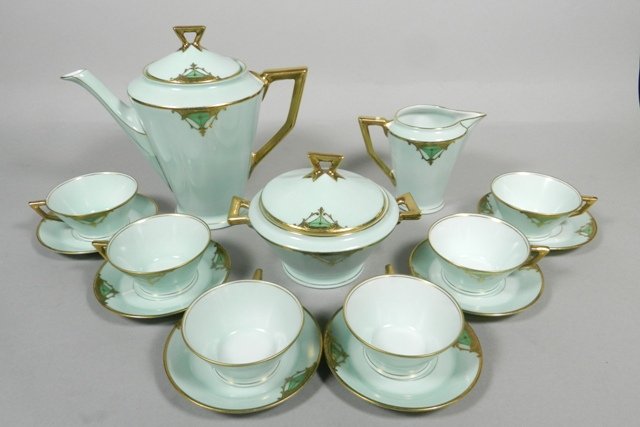 Gloria Bavarian Gilt Rim Green Porcelain Tea Set: Signed Gloria porcelain tea set, light green color, gilt rim and raised enamel decoration including: teapot, creamer, sugar bowl and six cups and saucer. Teapot H 7 1/2". Overall good condition, minor