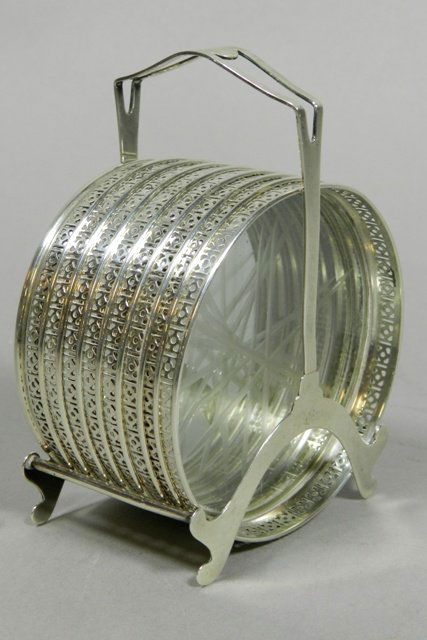 Webster Co. Sterling Coaster Set: Set of 8 Sterling silver rimmed coasters with glass bottom. Contained in its original sterling silver frame. Good condition overall.