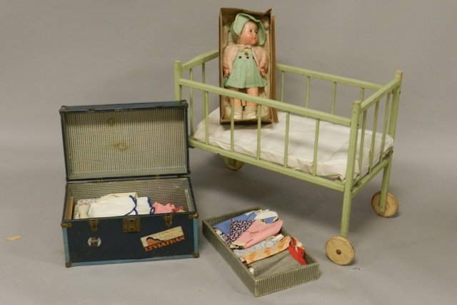 The Dionne Quintuplet Doll Marie & Accessories: Including Crib, trunk with cloths and Marie Doll. Some Crazing, original box.