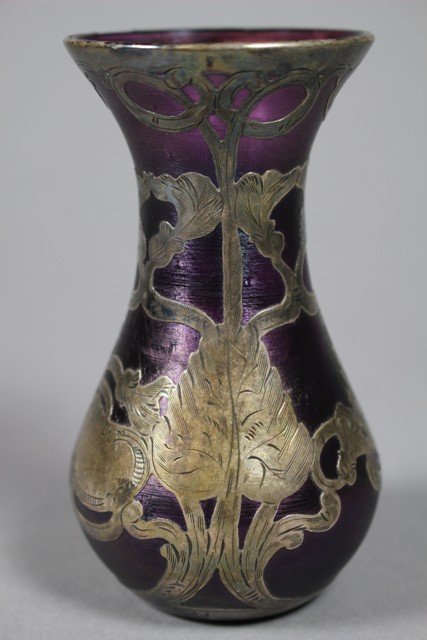 La. Pierre Loetz Sterling Overlay Art Glass Vase: Loetz Sterling Overlay Art Glass Vase, La. Pierre sterling faintly signed on top rim area. Glass is an iridescent Amethyst color and a floral ART NOUVEAU sterling overlay motif. Ca. 1900-1910. Unmarke