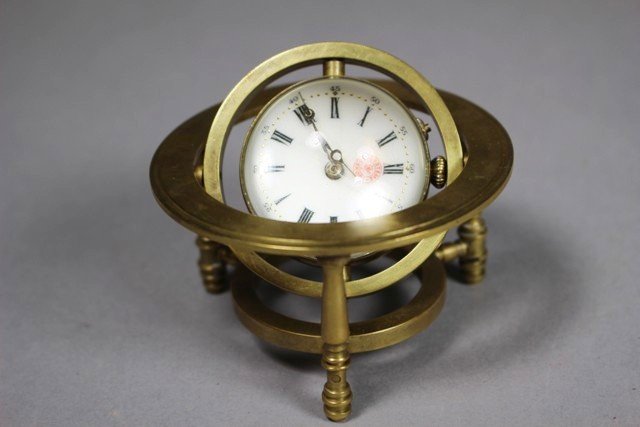 Systeme Roskopf German Ball Desk Clock: Systeme Roskopf German Ball Desk Clock contained in brass rotating frame. Has some minor condition issues on face and one hand lose, mechanics seem to move freely although need some attention. Approx.