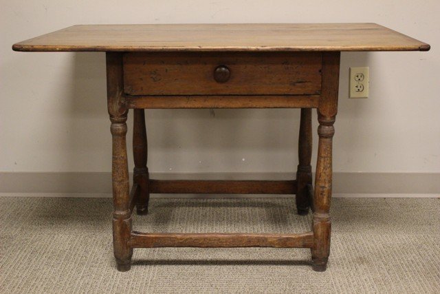 Early 18th Century Yellow Pine and Mix Wood Table: Early 18th century mixed wood work table with center drawer, yellow pine base, 5" over hang top and back- sides 9 1/2", continuous stretcher base, overlapping top, and bread board ends. Country crafts
