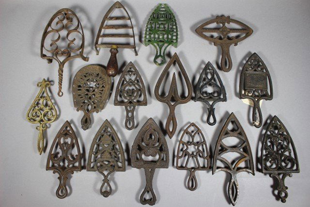 Group of 16 Cast Iron Trivets: Group from late 19th century through the early 20th century. Including all round designs, some with handles, claw feet and others. Various NY, Chicago, Ohio, ives and Allen kutactlee and others. Norma