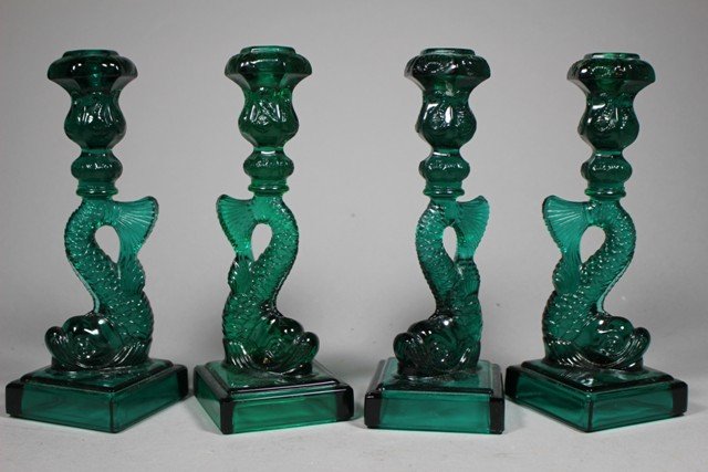 Two Sets of Green Dolphin Single Glass Candlesticks: Two sets of serpent/ dolphin style glass candlesticks, all marked "MMA" on lower base, good condition. H 11" x W 4".