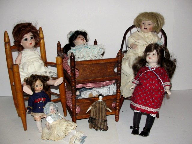 Group Lot Of Children's Dolls And Doll Furniture: Lot includes recent vintage bunk beds, Windsor arm chair, with crack in arm 13'' tall antique splint seat doll chair13'' tall breaks in splint strips, German late 20th. C. bisque head character baby,