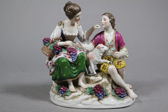 Dresden Porcelain Figural Couple with Lamb: Dresden porcelain figurine, woman feeding a man grapes with lamb in between, hand painted. Marked on bottom as shown. H 7 1/2" x W 7". Good condition, minor flea bites in a couple spots.