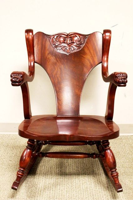19th Century North Wind Face Carved Rocking Chair: ca 1880 refinished mahogany rocker, carved North wind face back with dolphin or serpent carved arms. H. 32" W. 23" D. 32".