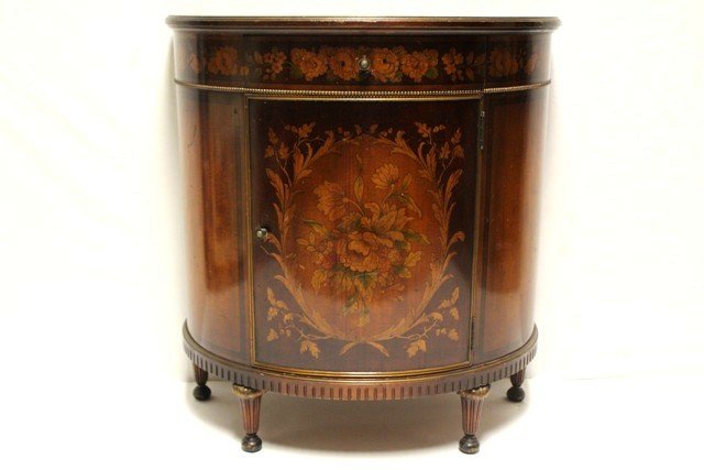 English Demi Lune Hall Cabinet: Early 20th century, ca 1910, mahogany satinwood hall cabinet with floral stenciled and inlaid front drawer, reeded legs, one pull out drawer. Light signs of use. H 32" x W 30" x D 14". Surface has som