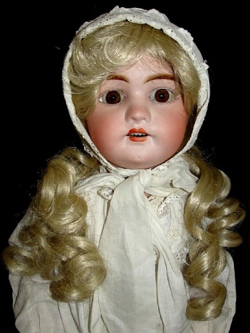 Bisque Head Mignon Felix Arena (Biplane Logo): Bisque socket head doll by Felix Arena marked Germany (biplane logo) Mignon 2 1/2. Open mouth with 6 teeth, sleep brown eyes. Fully jointed wood and composition body. . Circa 1920. 25'' Tall. Conditio