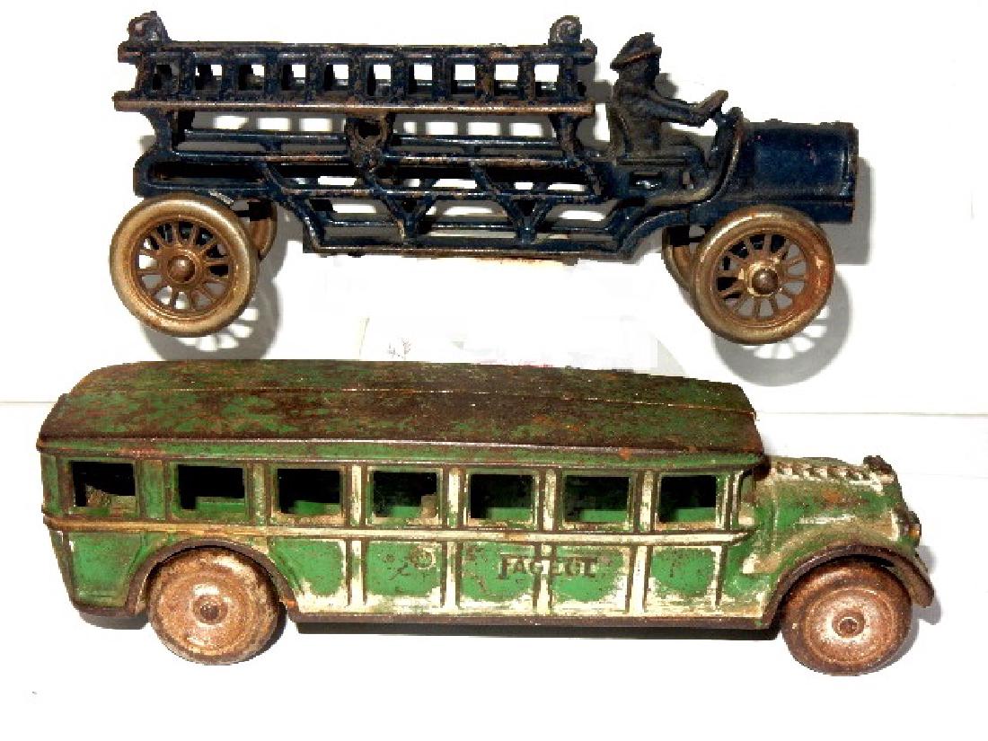 Cast Iron Dent Hardware Fire Truck & Fageol Bus: Arcade cast iron Fageol green bus with 7 windows on each side. Condition overall good with paint wear and light surface rust, H. 2 1/4'' L. 8'' D. 2''. Rare Dent Hardware 8" long cast iron hook & ladd