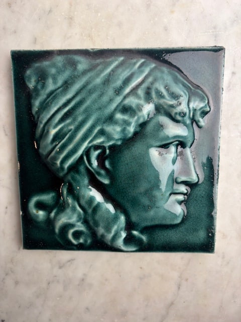 Neoclassical Art Tile, Classic Female Portrait Tile, Deep Teal Color: The tile exhibits characteristics of the Neoclassical period, popular in the late 1800s, featuring a classical female profile with flowing hair and a draped head covering. We have other tiles in this