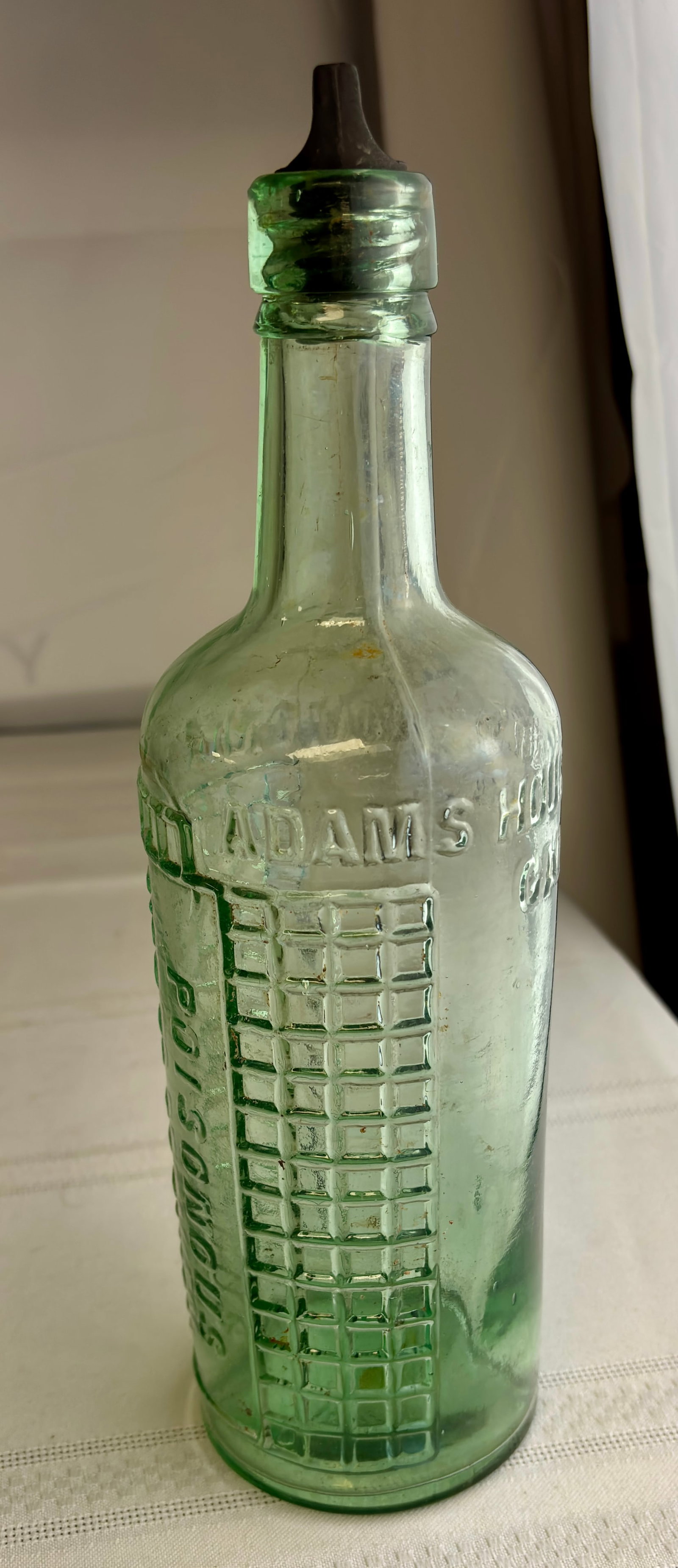 Antique Light Aqua Ammonia Poison Bottle - Adams Brand, 16oz: Antique ADAMS brand ammonia poison bottle. Has textured check pattern running on each side of bottle. Has a screw lid that fits, not sure if original to bottle. Appears to be in good to very good