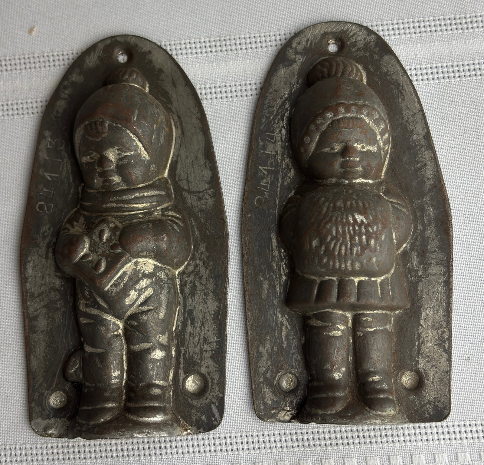 Antique Metal 2-Sided Chocolate Mold - One Side Girl, One Side Boy: Antique Metal 2-Sided Candy Mold - One Side Girl, One Side BoyThere are some item numbers on the left side of tins as you can see from photo. In good overall condition, some slight rusting to areas,