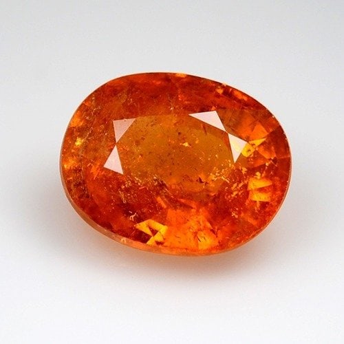 5.68 Cts IGI Certified Spessartite: Fiery 5.68ct IGI-certified spessartite garnet with warm orange-red saturation.