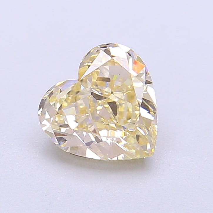 1.41 Lab Grown Diamond FANCY LIGHT YELLOW HEART Shape: An elegant a 1.41 ct lab-grown diamond in Fancy Light Yellow, cut with a balanced heart shape with sweet appeal. Crafted to elevate a three-stone ring, this stone delivers a soft, luminous tone with a
