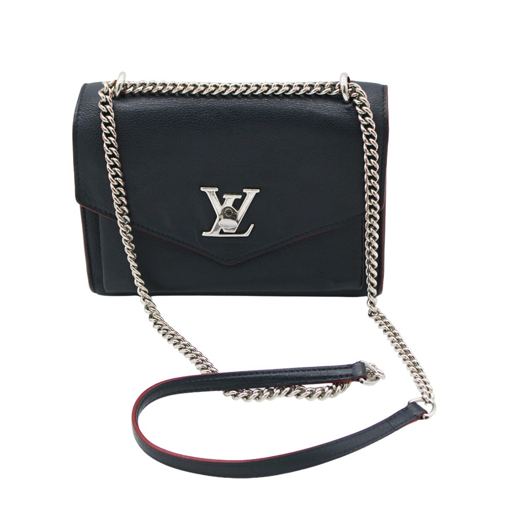 Louis Vuitton Mylockme BB Leather Shoulder Bag: Louis Vuitton Mylockme BB shoulder bag crafted in navy blue leather. Features a structured silhouette with the signature turn-lock closure and a refined, compact profile. Finished with a sleek strap f