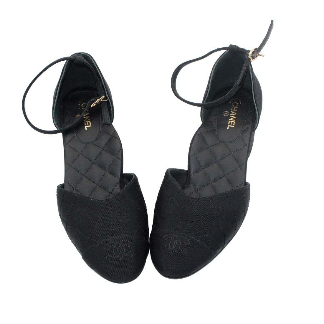 Chanel Black Quilted CC Ankle-Strap Flats: Black quilted flats featuring Chanel’s signature interlocking CC logo on the toe cap and a delicate ankle strap. Marked. Includes dust bag. Size: EU 39.