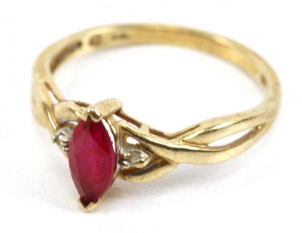 10K YELLOW GOLD SPINEL & DIAMOND RING: A 10k yellow gold ring with spinel stone and 2 small accent diamonds. Spinel measures approximately 9mm. Ring size 7. Weighs 1.5 grams.