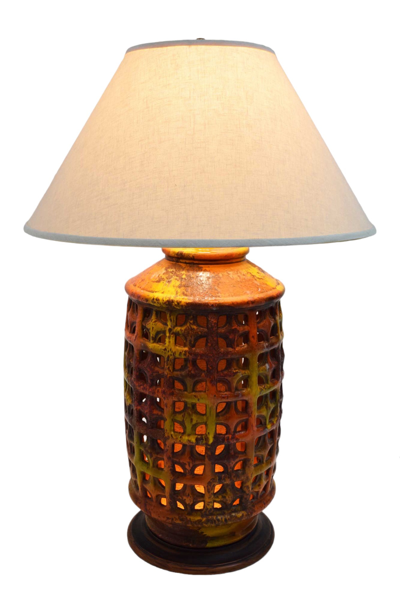 Mid-Century Modern Large Pierced Ceramic Lamp in Ochre, Paprika, and Caramels: Beautiful lamp with grid pattern pierced ceramic. Measurements are too top of harp and diameter is base if lamp. Drip glaze finish in ochre, brown, caramel and paprika. Fabulous scale, range of color