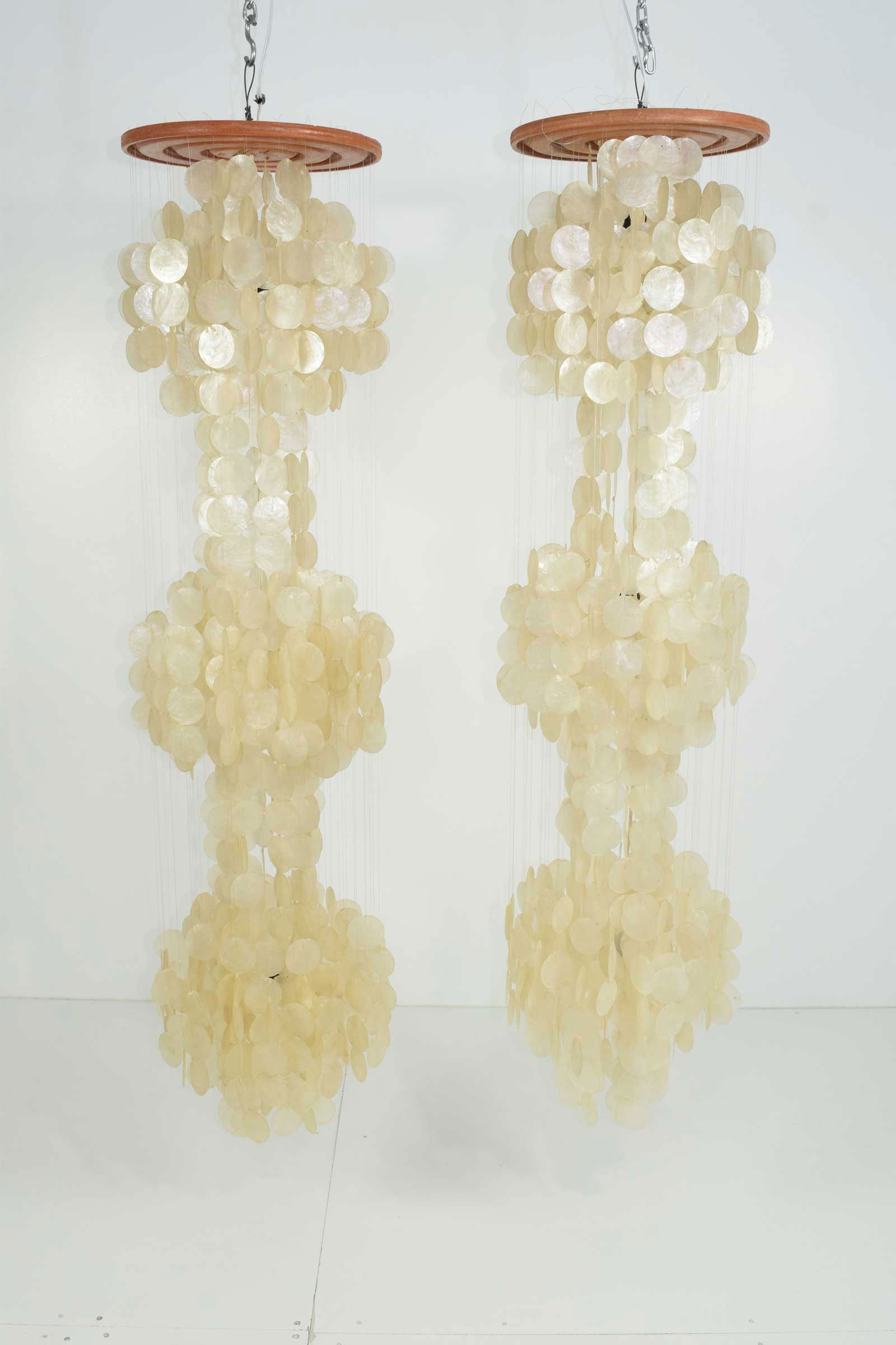 Pair of Very Large Verner Panton Style Capiz Shell Chandeliers: Wood tops. Measures: These are over 5' long. Hang these over bedside tables for drama. Stunning.