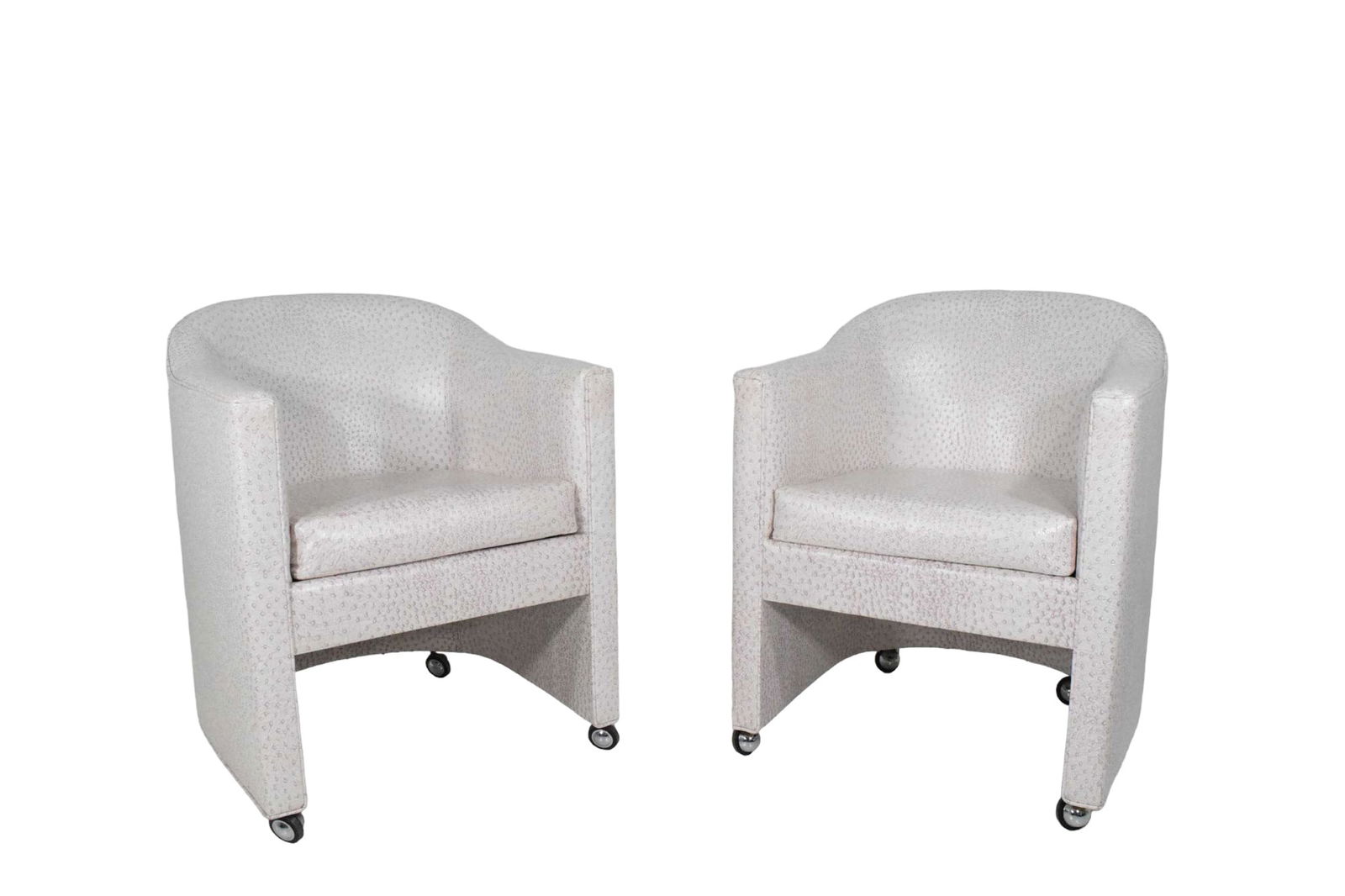 Pair of Club Chairs by Preview Furniture Company: Very nice chairs in a faux ostrich vinyl, these chairs effortlessly exude mid-century modern elegance while offering practical functionality. Set on casters, they provide easy maneuverability, making