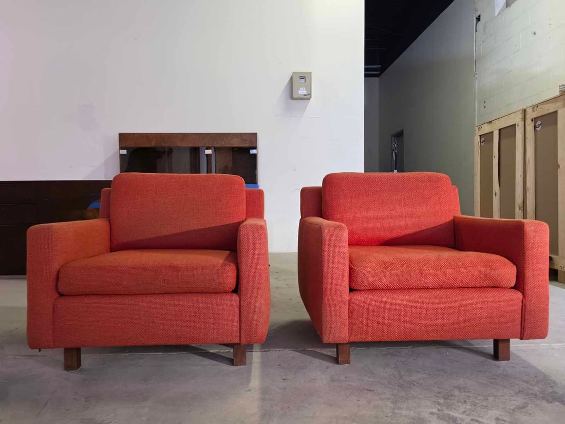1960s Cube Lounge Chairs in the Style of Milo Baughman: Bold pair of 1960s cube lounge chairs in the style of Milo Baughman, featuring a classic mid-century modern silhouette with clean lines and a structured cube form. The vibrant orange upholstery adds a