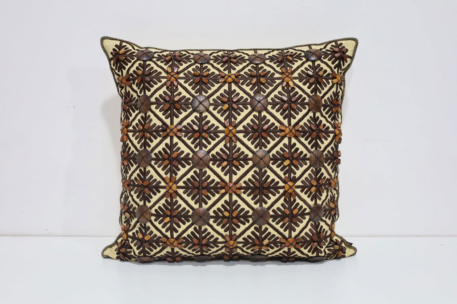 Pillow with Brown Wood Accents: Great looking pillow with attached wood accents