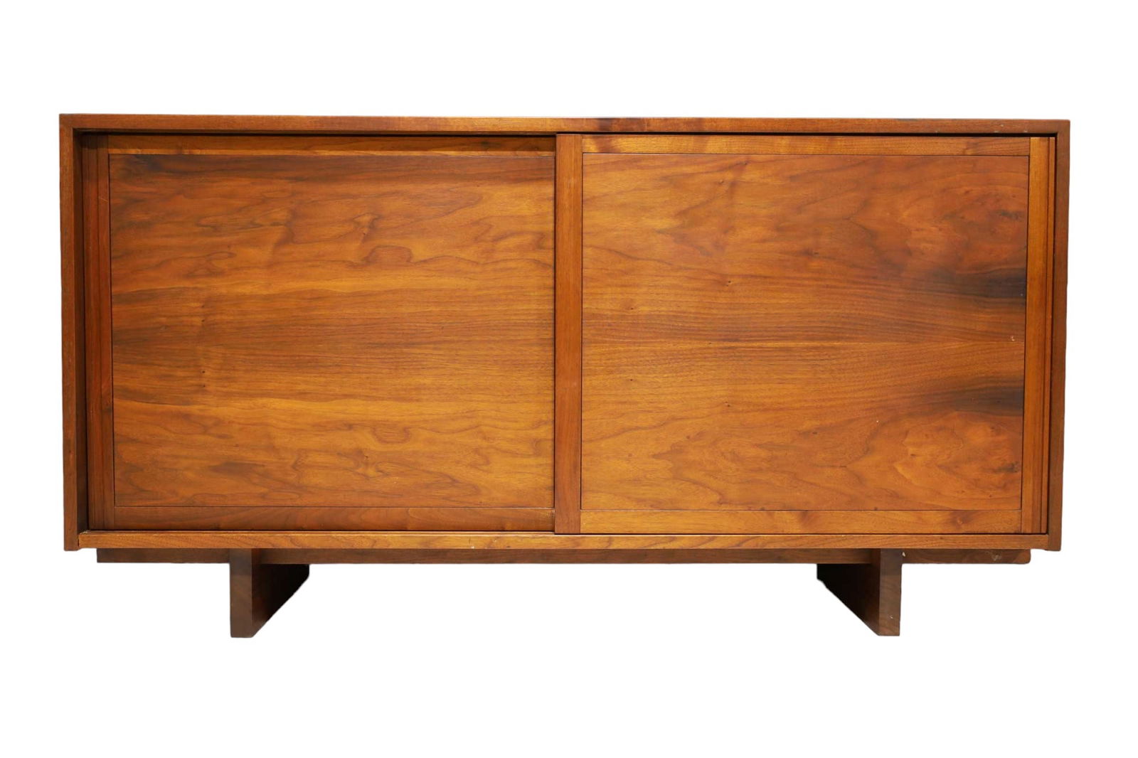 George Nakashima Walnut Sideboard, 1961: George Nakashima Walnut Sideboard, 1961. This walnut sideboard is 60" in width, featuring a straight edge top, wood doors, and striking sub sap streak top and sides. Designed with 4 drawers on the lef