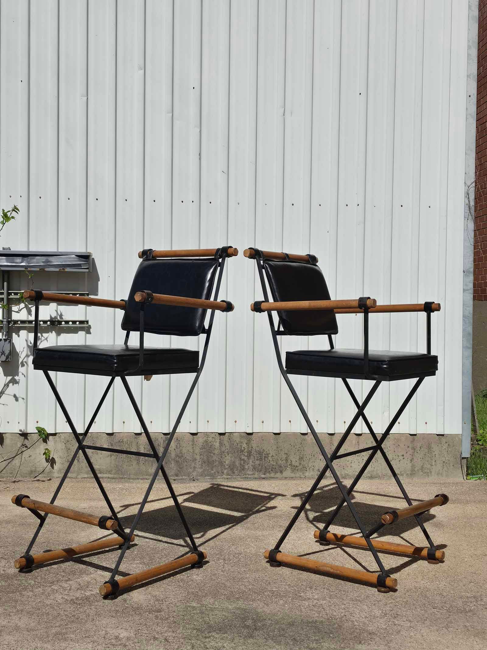 Cleo Baldon Bar Stools: Stylish pair of vintage bar stools by Cleo Baldon, known for her iconic indoor-outdoor modern designs. These stools feature a sleek metal frame with comfortable black vinyl seats, offering a minimalis