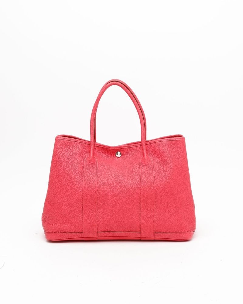 Hermès Pink Negonda Leather Garden Party 36 36 Handbag: Hermès Negonda Garden Party 36 Tote Bag in pink negonda leather featuring silver-tone hardware, dual handles, and a beige lining with one pocket. Includes a vintage serial number from 2014.