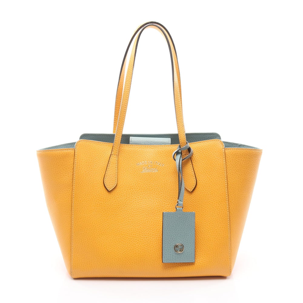 Gucci Swing Tote Bag: Gucci Swing shoulder tote bag in orange yellow leather.