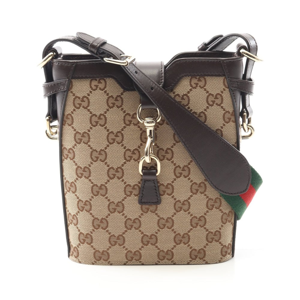 Gucci GG Shadow Mini Baguette: Gucci GG Shadow mini baguette shoulder bag in beige and dark brown canvas and leather.