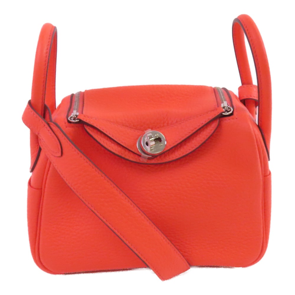 Hermes Mini Lindy Crossbody Bag: Hermes Mini Lindy shoulder crossbody bag in Rose Texas orange Clemence leather with silver hardware.
