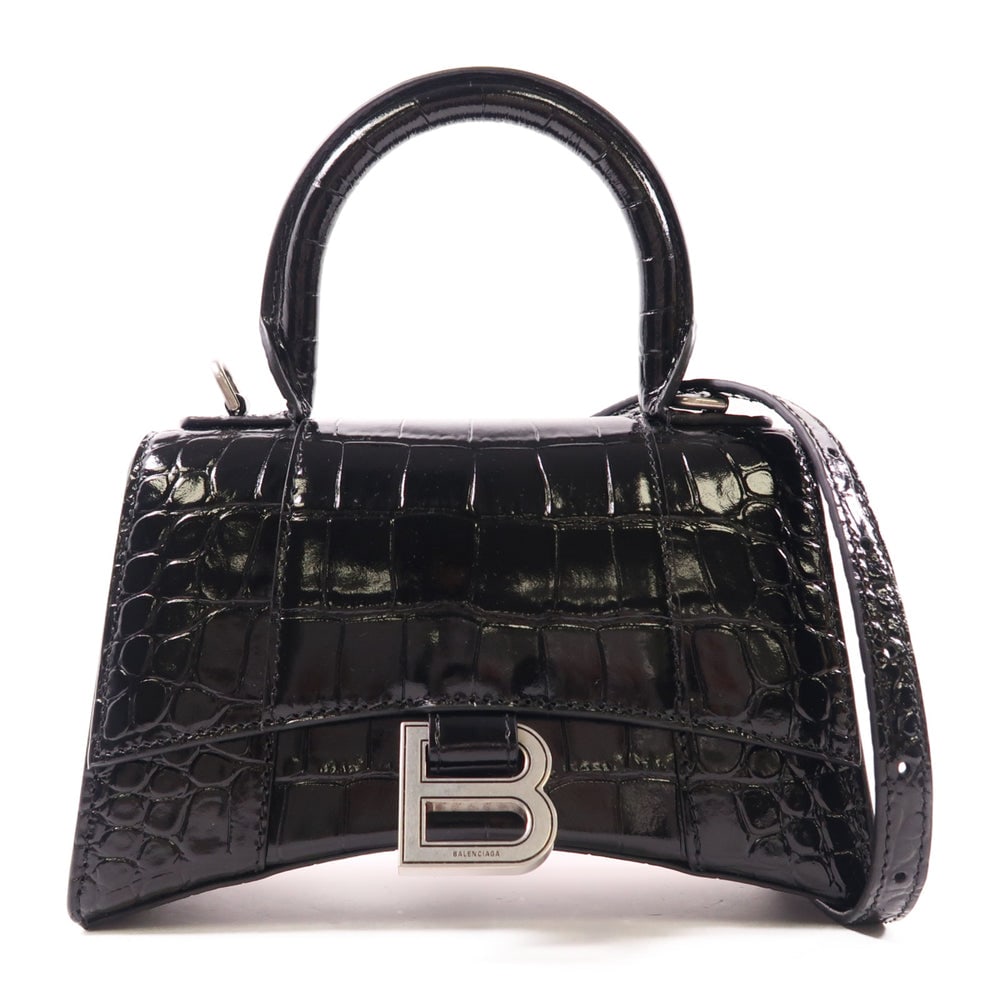 Balenciaga Hourglass XS Black: Black calfskin Hourglass top handle 2Way bag. Includes storage bag and strap. 19 x 12 x 7 cm.