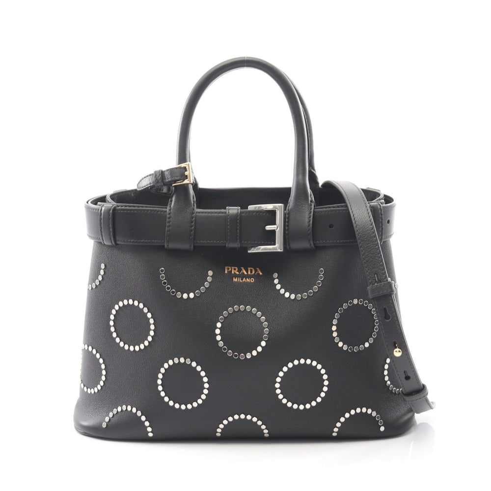 Prada Soft Grain Buckle Tote: Black leather studded 2Way tote. Includes shoulder strap and poignet. 31 x 22 x 12 cm.