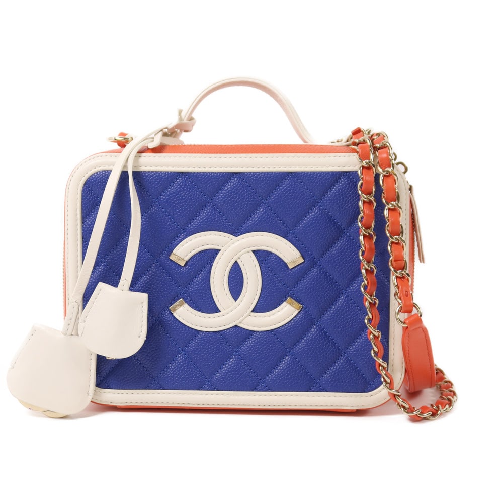 Chanel Filigree Vanity Blue: Blue and white calfskin small vanity chain shoulder bag. Includes storage bag hologram guarantee key and padlock. 20 x 15 x 7.5 cm.