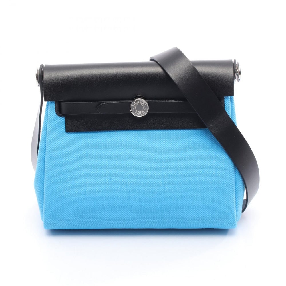 Hermes Herbag Zip Mini Blue: Blue and black toile military and leather shoulder bag. Includes stopper. 20 x 16 x 7 cm.