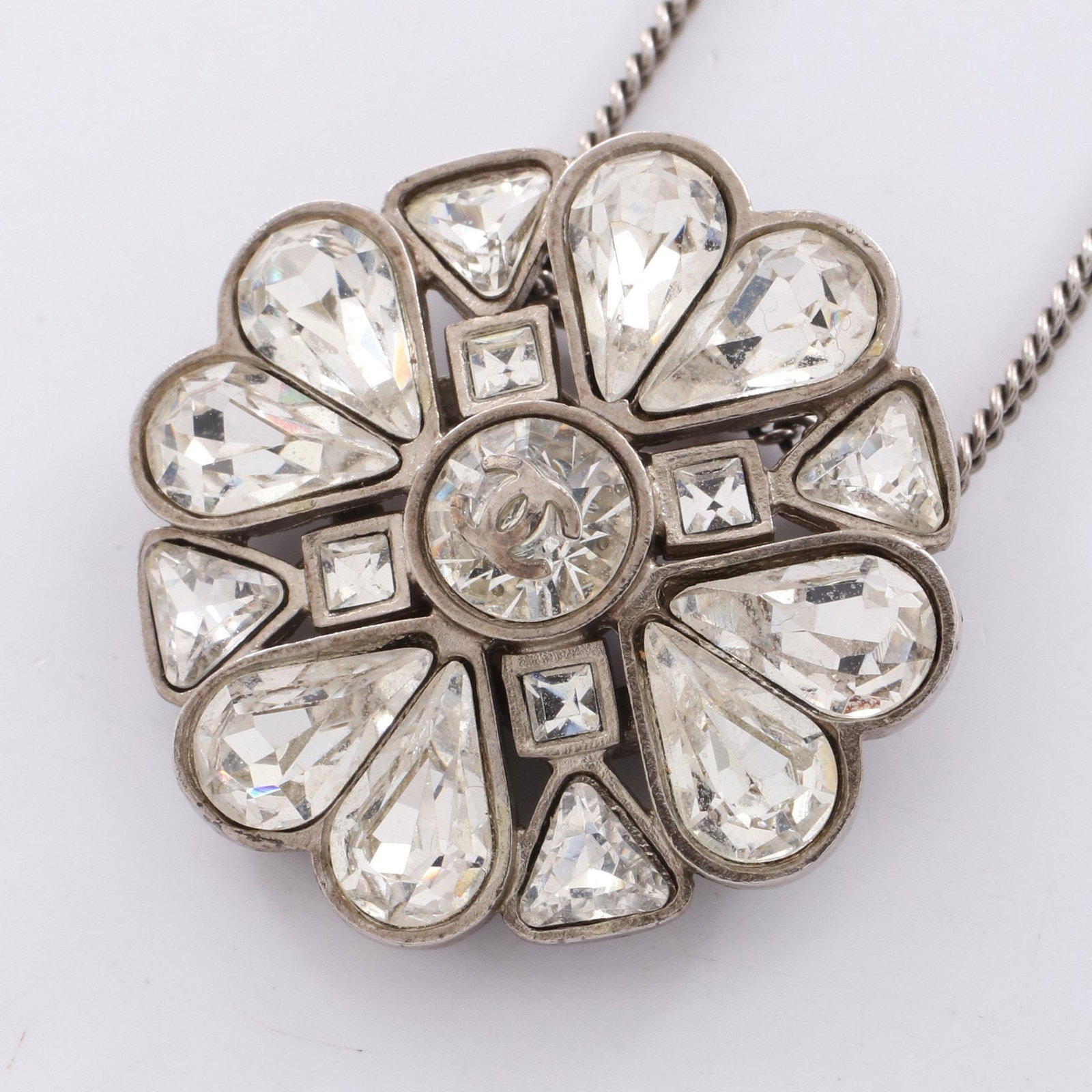 Chanel Clover Coco Mark Silver: Clover Coco Mark necklace in silver tone with clear crystal.